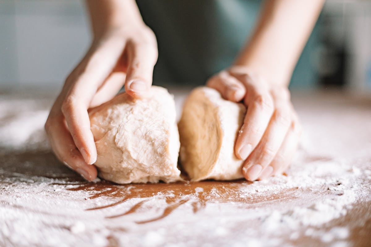 Hands working dough
